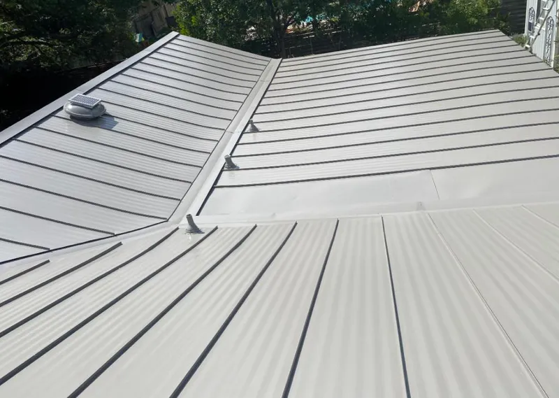 Solar attic fan installed on a metal roof for Roof Ventilation in College Station